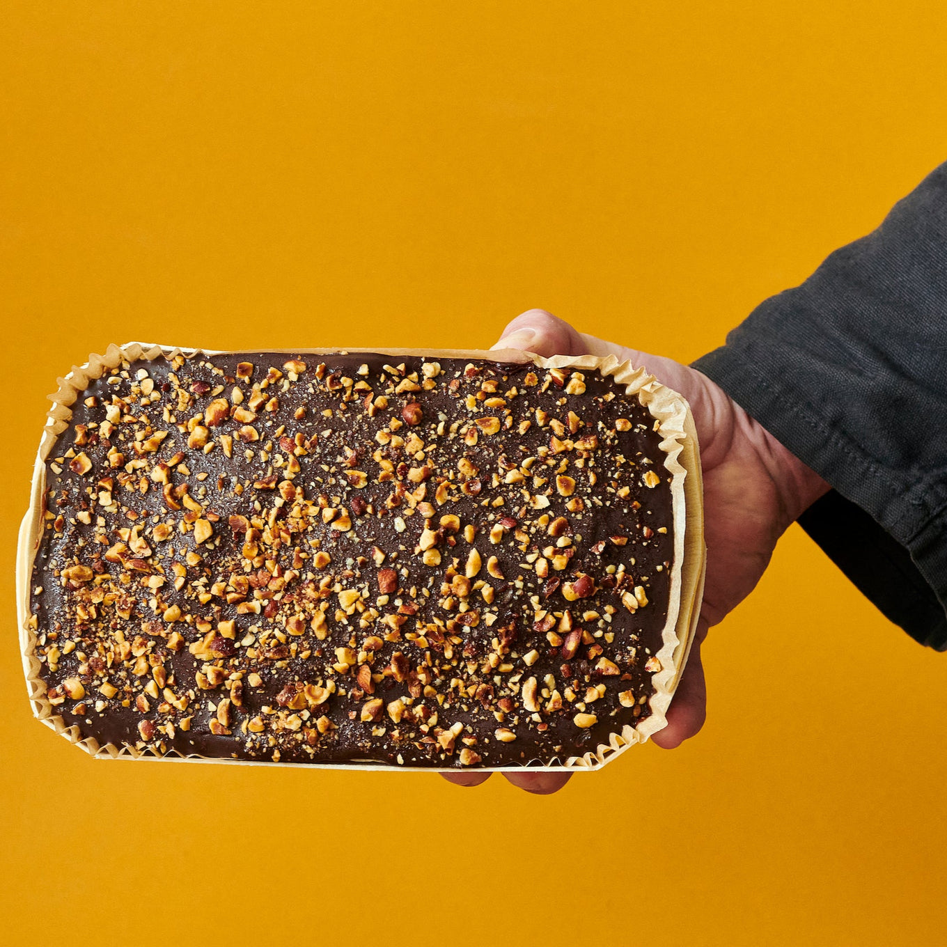 Exploding Bakery Ambassador's Cake held out