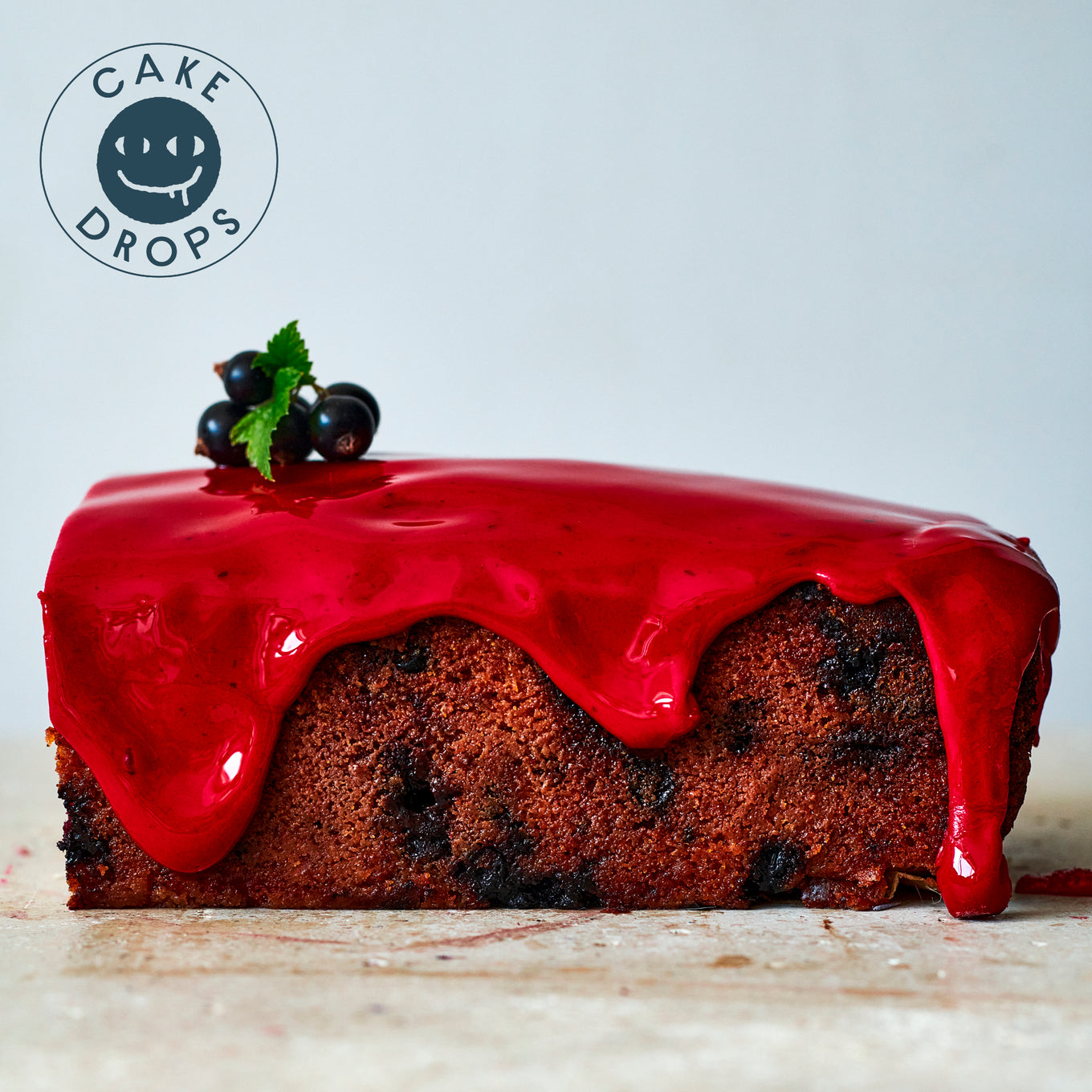 a slice of Blackcurrant Friand Loaf garnished with blackcurants
