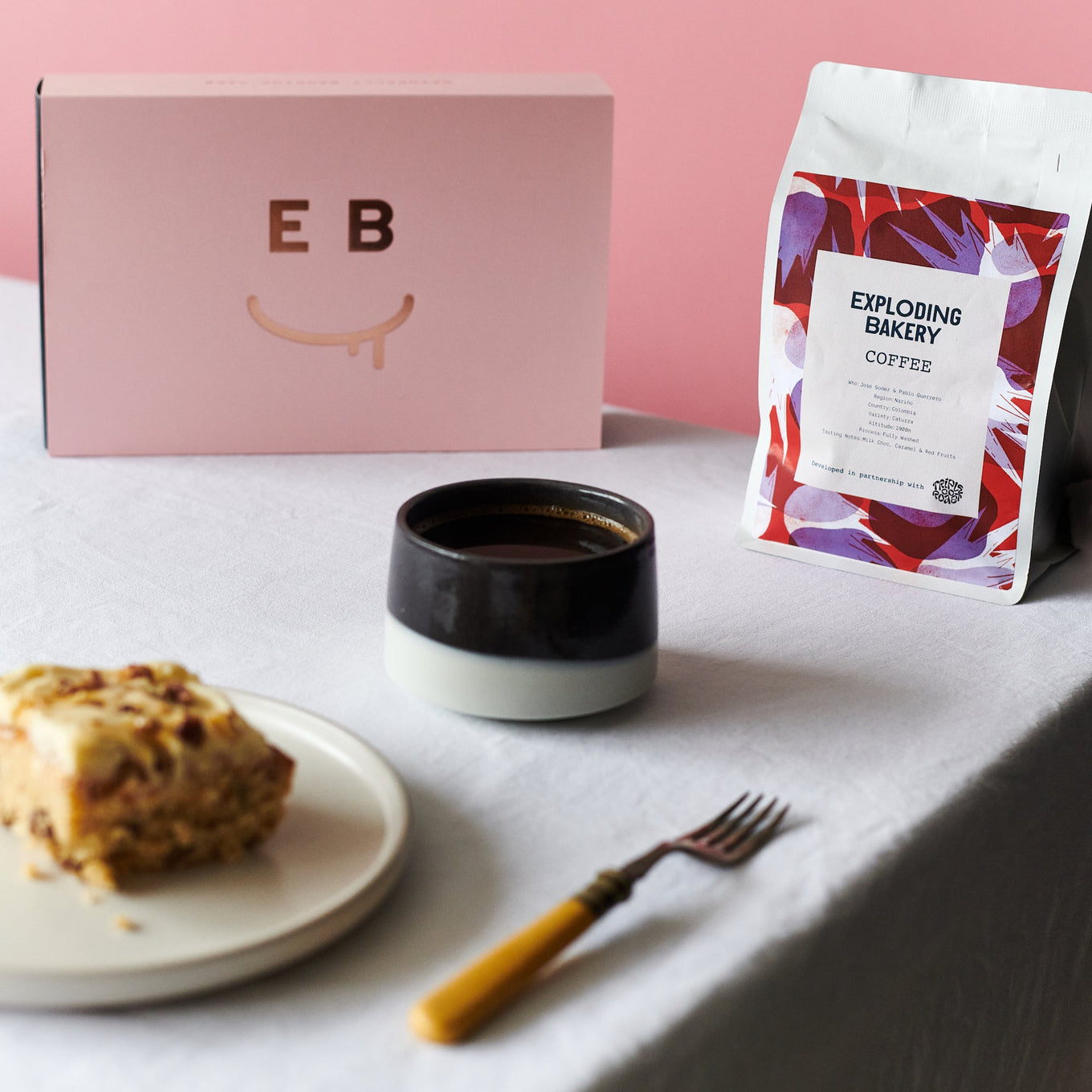 Tripple Co Coffee and a cake on a table