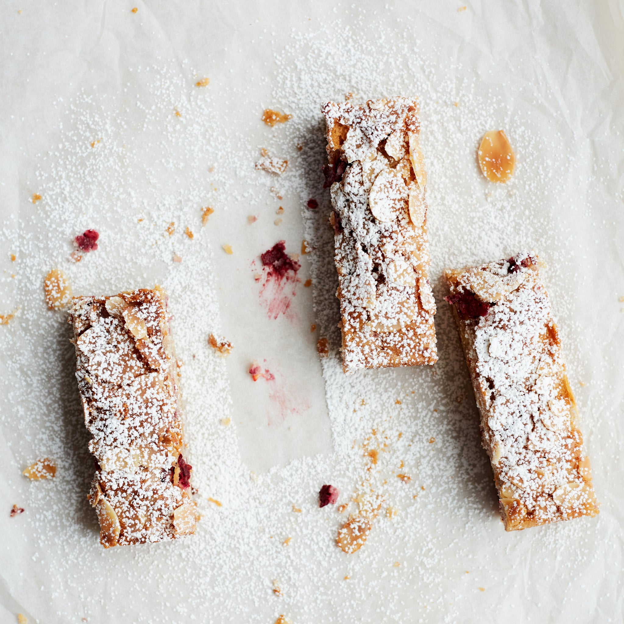 Portions of Exploding Bakery Raspberry and White Chocolate Frangipane Traybake.