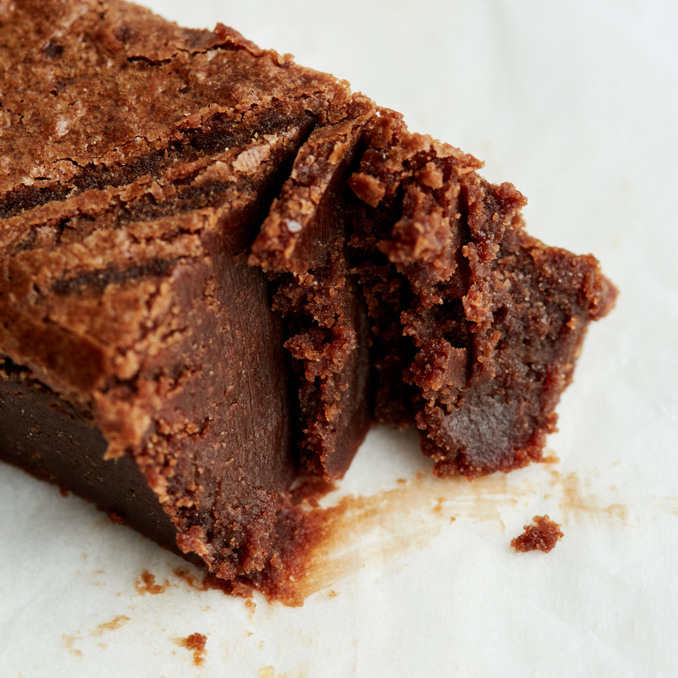 An Exploding Bakery Almond Brownie Traybake portion partly eaten.