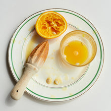 Slice of orange on a plate.