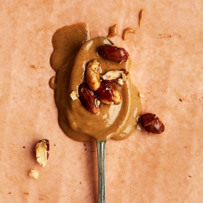 Peanut Butter with Peanuts on a spoon.