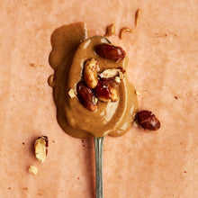 Peanut Butter with Peanuts on a spoon.