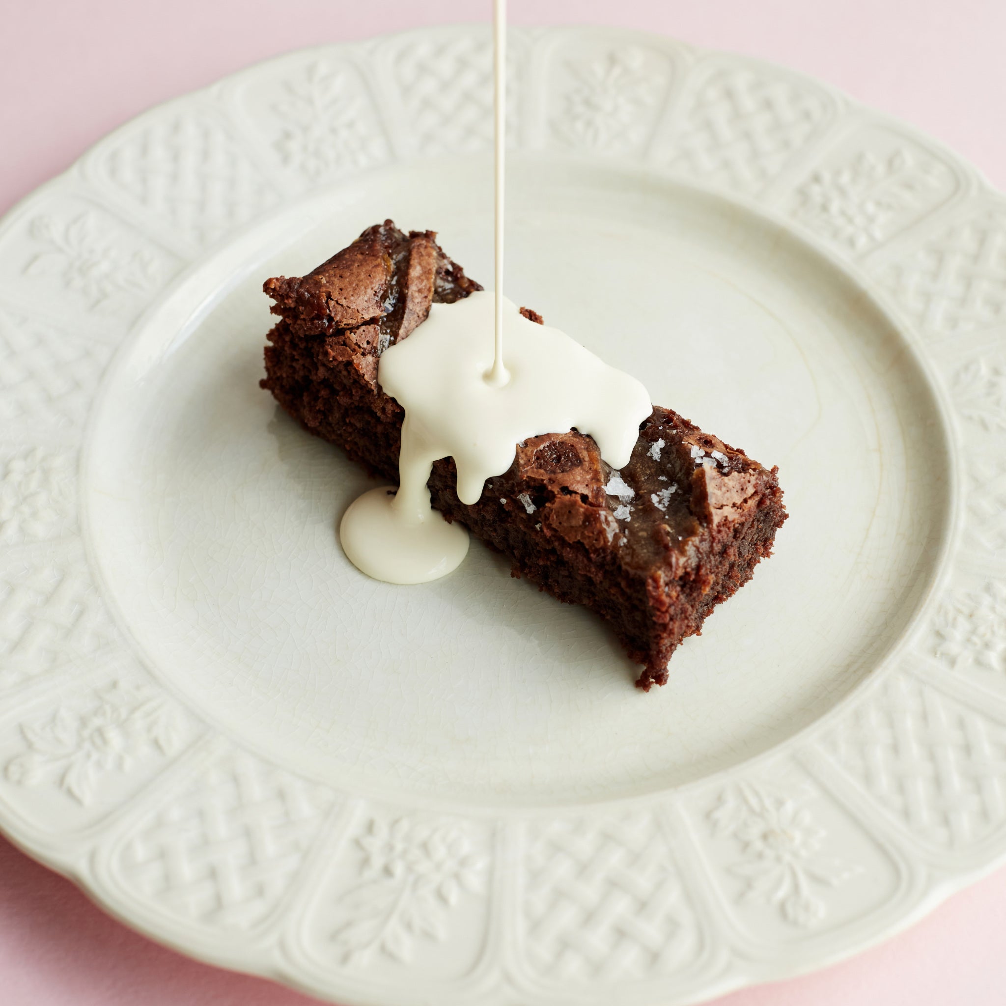 Exploding Bakery Salted Caramel Brownie Traybake portion with cream.