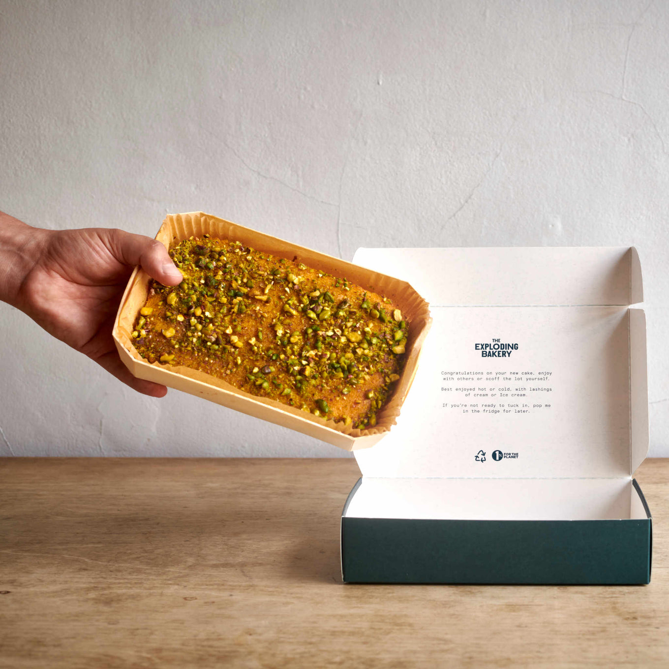 Exploding Bakery Lemon Polenta and Pistachio Cake being placed into delivery packaging.