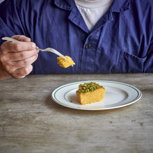 A portion of Exploding Bakery Lemon Polenta & Pistachio Cake being eaten.