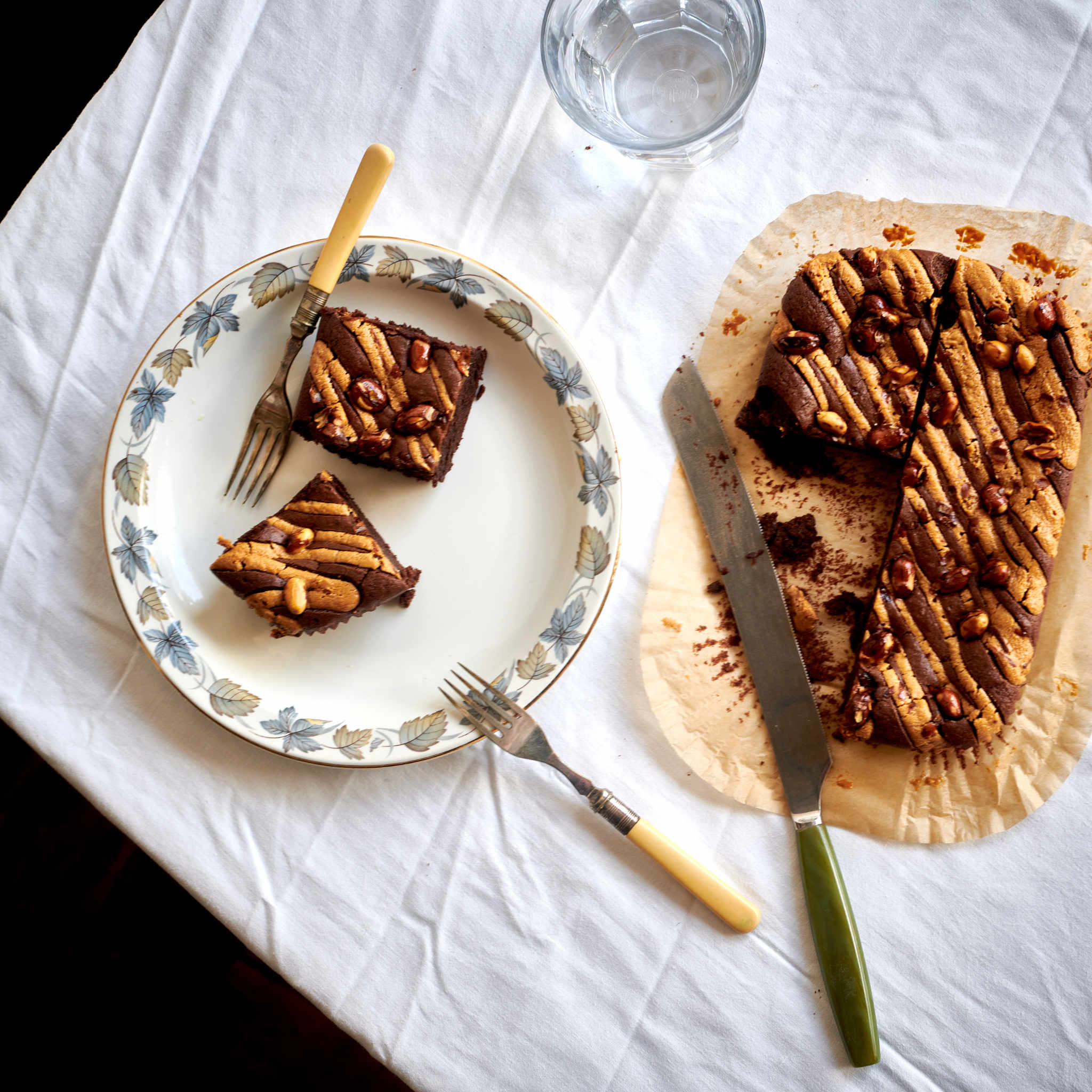 Exploding Bakery Peanut Butter Vegan Brownie cut up with a portion placed on a plate.