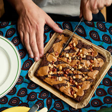 Exploding Bakery Peanut Butter Letterbox Brownie being cut into portions.
