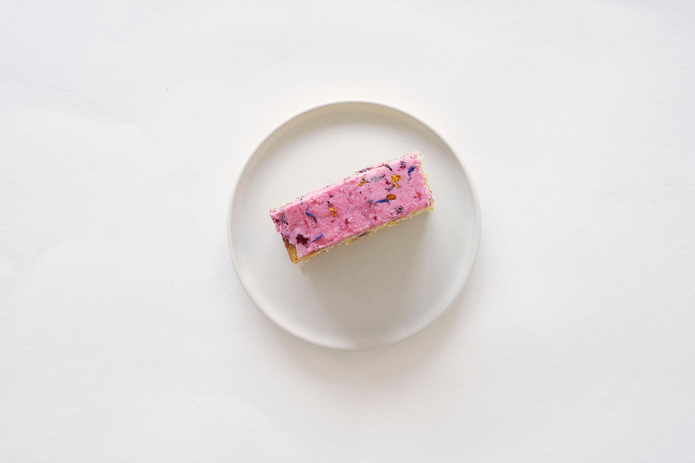 An Aerial Shot Of A Plated Slice Of Berry Citrus Cake