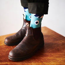 close up of someone in Exploding Bakery Socks and boots with turned up trousers