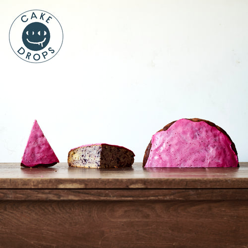 Three slices of Blueberry Cake photographed from the side on a Woden table