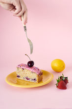 Someone Holding A Fork Above A Plated Slice Of Berry Citrus Cake