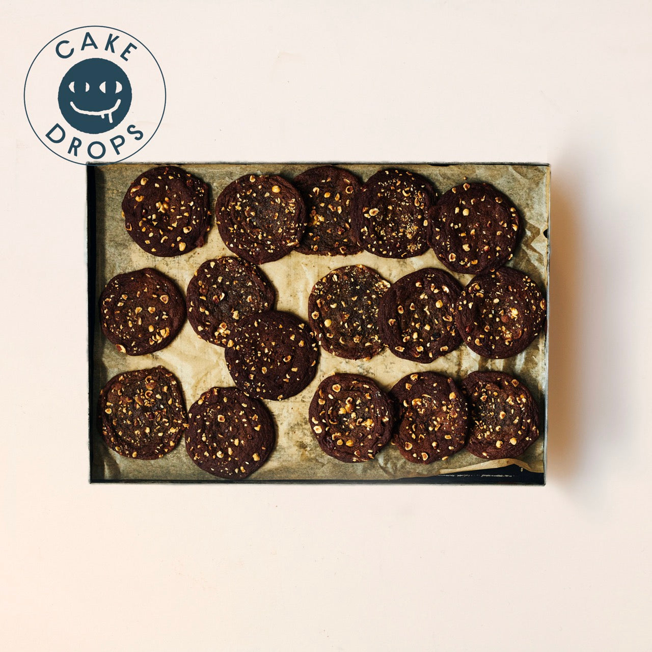 Hazelnut, Miso & White Chocolate Cookies in a baking tray photographed from above