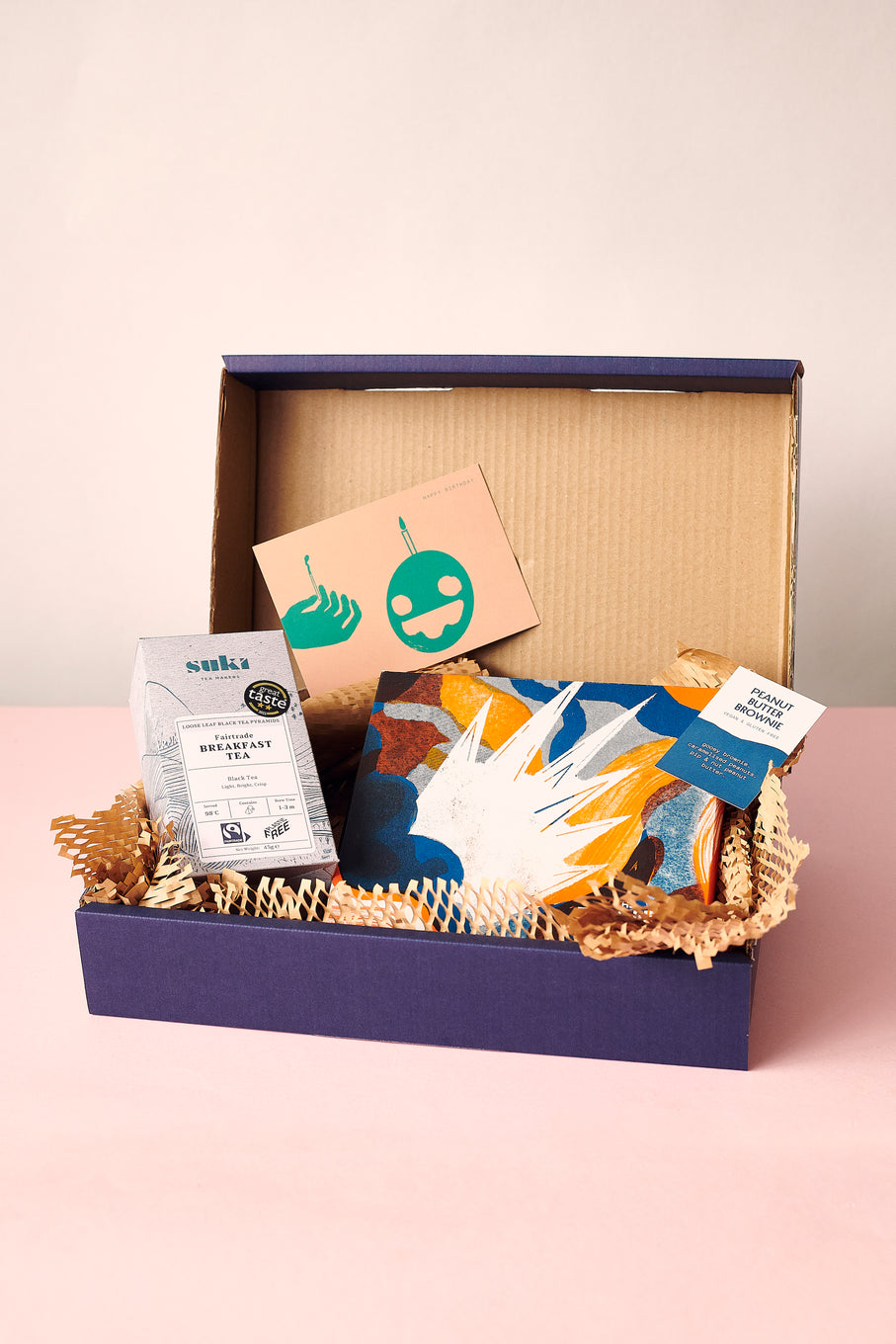 A open Hamper with Suki Tea, A Letterbox Brownie and a Gift Card