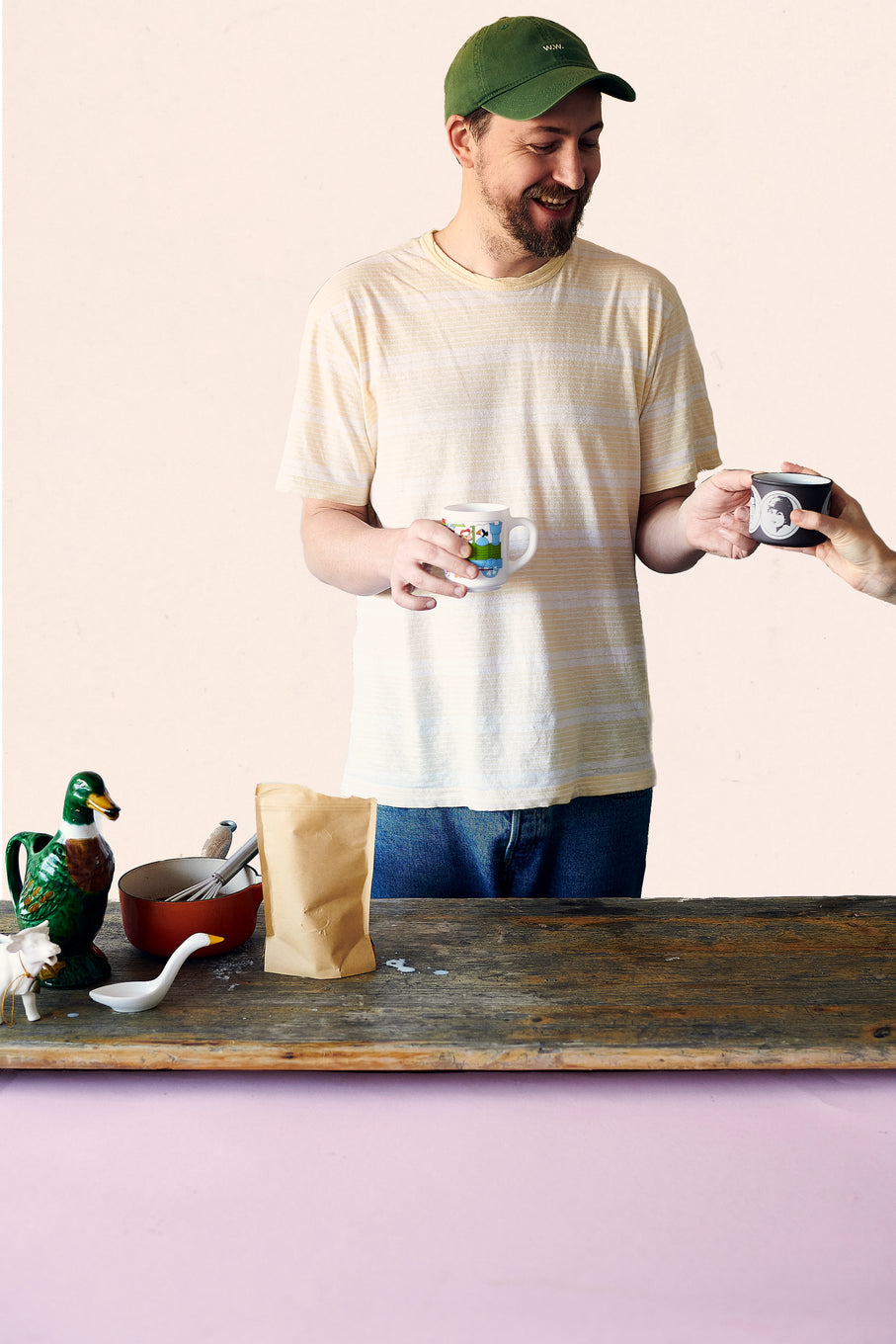 Somebody handing over a mug of Exploding Bakery Drinking Chocolate