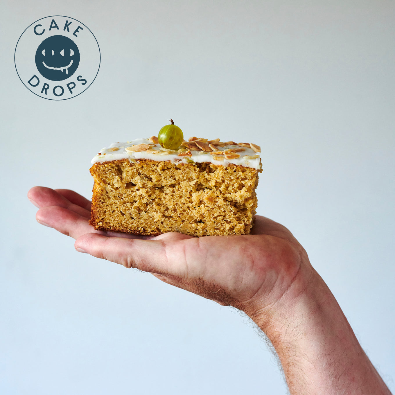 a slice of Gooseberry Cake in a hand
