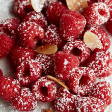 Raspberry and flaked almonds dusted with icing sugar.