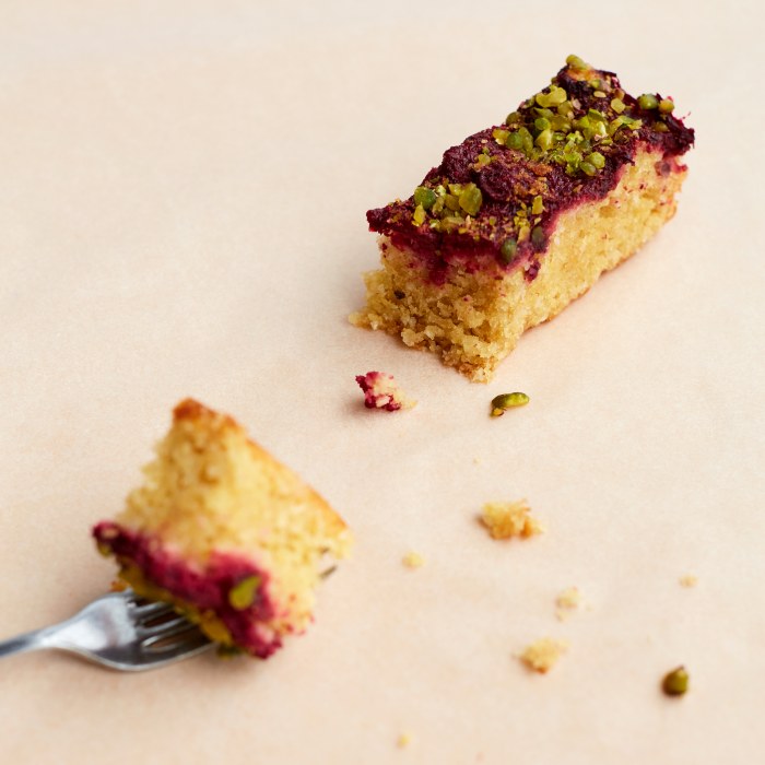 Sour Cherry & Pistachio cake portion with fork. Wholesale.