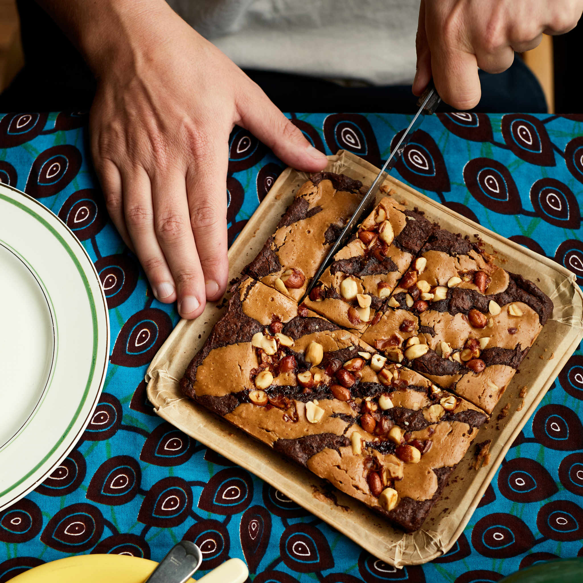 Exploding Bakery Peanut Butter Letterbox Brownie being cut into portions.